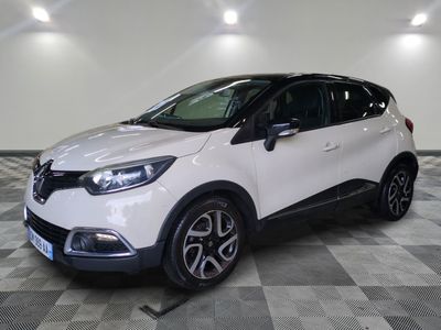 a white car is parked on a checkered floor in a garage