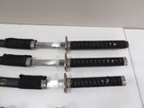 several knives are lined up on a white surface next to a pair of scissors