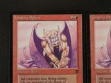 a close up of two cards with a picture of a demon