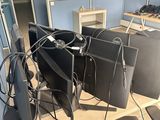 several computer monitors are sitting on a desk in an office