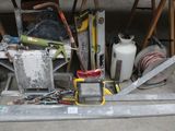 a pile of assorted items on the floor of a garage