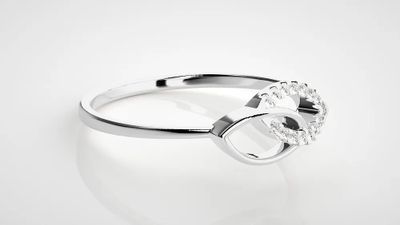 silver plated ring with a horseshoe and crystal stones on it