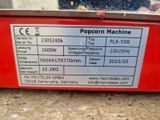 a close up of a popcorn machine with a price label on it