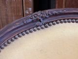 a close up of a chair with a wooden frame