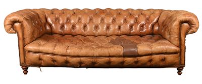 brown leather couch with a brown patch on the back of it