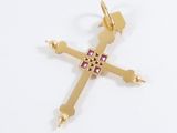 an image of a gold cross with a pink stone in the center