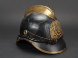 an old helmet with a lion on the side of it on a black surface
