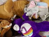 a pile of stuffed animals and stuffed animals on a bed