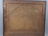 an old wooden picture frame with a small hole in the middle