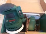 a box with a sander and other tools in it