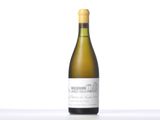 the bottle of white wine is sitting on the table