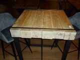 a wooden table with four chairs around it in a room