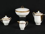 three pieces of white and gold tea and coffee set on a black background