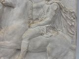marble relief of a man on a horse with a woman on a horse