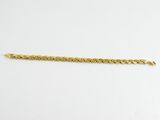 a gold bracelet with a chain on a white background