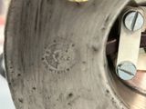 a close up of a metal object with screws on it