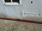 the side of a building with a hole in the wall and a hole in the floor