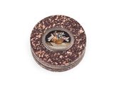 a small round box with a picture of a man on it