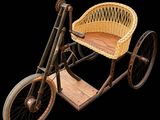 un vélo en osier muni d'un panier à l'arrière