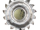 a metal sunflower with a mirror in the middle of it