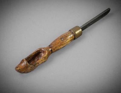 a close up of a knife with a wooden handle on a table