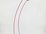a black table lamp with a red cord and a white background