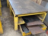 two yellow tables are stacked on top of each other in a warehouse