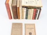 several books are stacked on top of each other on a white surface