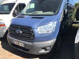 a blue van that is parked in a parking lot