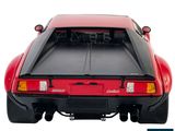 the back end of a red sports car with its hood open