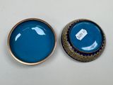 pair of blue and gold vases sitting on top of a white table