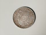 a close up of a coin on a table with a white background