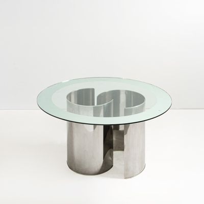 an image of a glass table with a metal base and a circular glass top