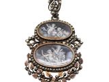 a close up of a pendant with two pictures on it