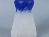 a blue and white salt shaker sitting on a table