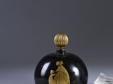 pair of black and gold glass perfume bottles with a gold lid