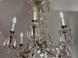 a crystal chandelier hanging from the ceiling in a room