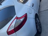 a white car that is parked on the side of the street