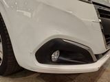 a close up of a white car in a showroom