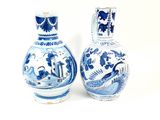pair of blue and white vases with birds and flowers on them