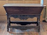 a wooden table with a wooden top on a wooden floor