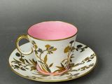 a close up of a cup and saucer on a table