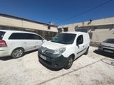 two vans parked in a parking lot next to each other