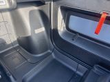 the interior of a car with the door open and the seat down