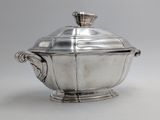 an antique silverplated sugar dish with a lid on a stand