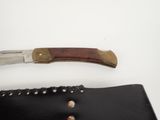 a knife that is laying on top of a wallet