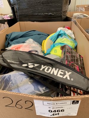 a cardboard box full of tennis rackets and other items