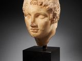 a roman marble head of a youth