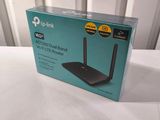 an open box of a wireless router sitting on top of a table