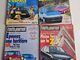 four magazines of different cars are on a table